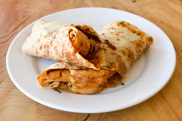 Lavash doner kebab ( doner zurna durum )  or shawarma sliced in plate isolated. 
