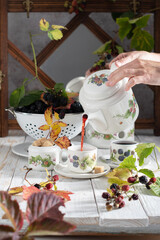 fruit tea with ripe blackberries, vintage still life with beautiful retro set 