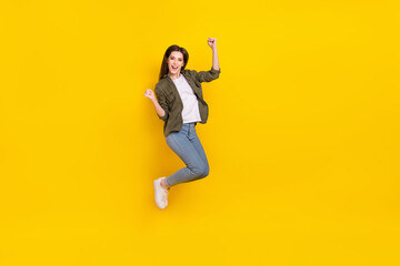 Fototapeta na wymiar Full size photo of overjoyed delighted girl jump up win money prize win giveaway lottery isolated on yellow color background