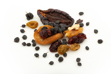 Various dried fruits on a white background. Walnuts, blueberries, currants, raisins, prunes, dried apricots
