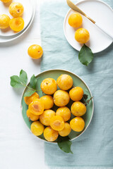 Fresh sweet yellow plums on the table