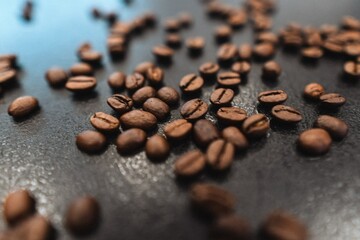coffee beans spilled on the dark surface