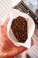Top view of white bag with roasted coffee beans