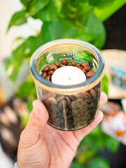 Lit candle filled with coffee beans