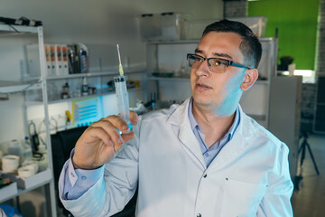 Male doctor holding a syringe in his hand