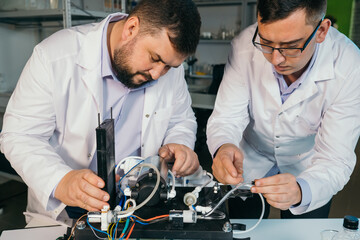 Young men are engaged in setting up a water purifier