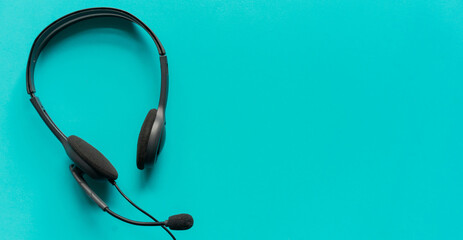 close up headphone call centre hotline on blue color background for help desk concept