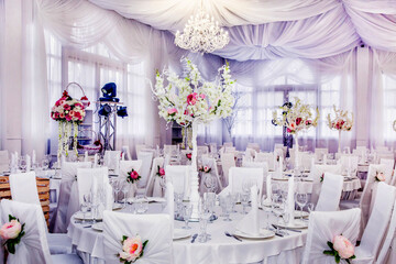 The table at the wedding banquet, served and decorated with floral arrangements