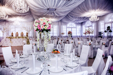 The table at the wedding banquet, served and decorated with floral arrangements