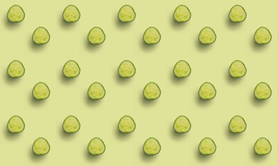 Seamless pattern of cucumber slices on a light green background. Healthy green food cucumber background