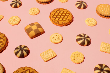 Cookies, retro style pattern on pastel pink background. 