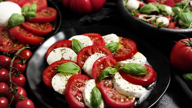 Salads with traditional italian burrata and mozzarella cheese with arugula and tomatoes