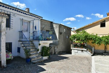 A narrow street among the old houses of Greci, a village in the Campania region, Italy.