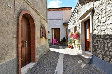 A narrow street among the old houses of Greci, a village in the Campania region, Italy.
