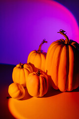Halloween pumpkins on neon gradient background. Happy Halloween decorations