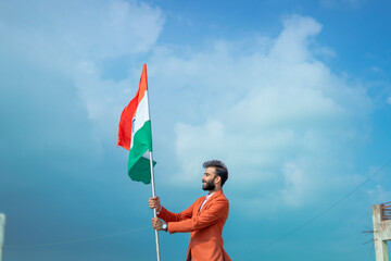  indian young man holding tricolour flag, independence day