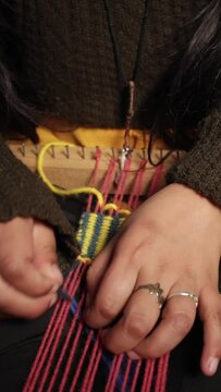 Square loom weaving with wool, needles, and rounded tip