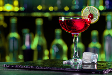 Cocktail in a glass on a bar counter in a restaurant, pub. Fresh prepared alcoholic cooler beverage at nightclub