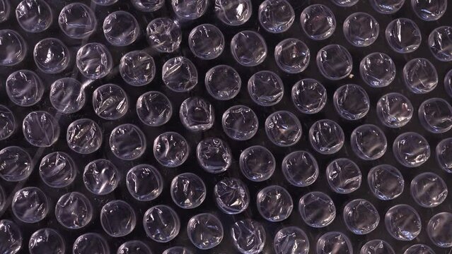 Packing bubble wrap. Slide shot of polyethylene packaging film texture. Slow dollar.