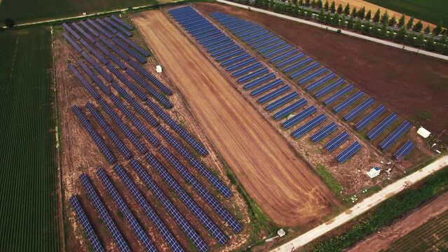 beautiful aerial view of solar panel cell on the field and Mt Osa in background, Greece. High quality 4k footage