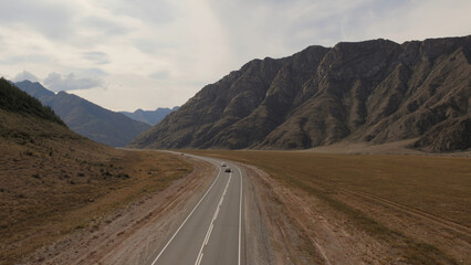 Chuya highway in mountains valley of Altai with traffic cars
