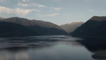 Lake Teletskoye between mountains in sunset in Altai