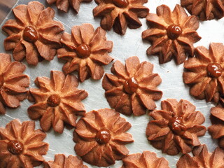 Top view flower shaped cinnamon butter cookies with caramel