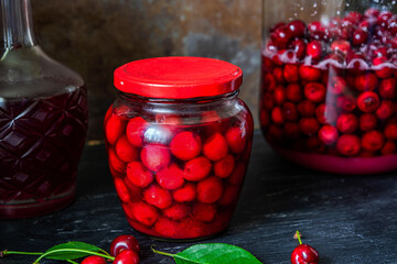 Homemade liqueur from cherries in a jar of a natural fermentation process. Ukrainian tincture.
