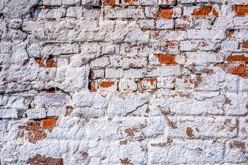 old brick painted wall with cracks