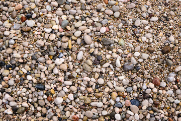Pebbles on the beach, natural background of small stones