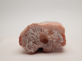 Frozen raw pork. Frozen raw meat. Piece of frozen meat.