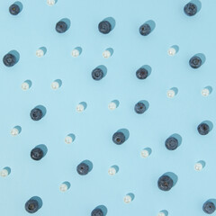 Pattern of blueberries and white pearls on pastel background. Value of healthy food concept.