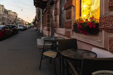 Cozy tables in a street cafe. Life in the city.