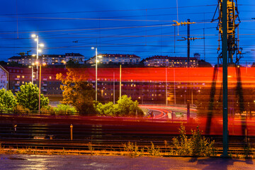 Train passing by at city in evening