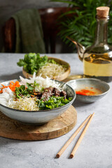 bowl of traditional Vietnamese salad - Bun Bo Nam Bo, with beef, rice noodles, fresh herbs, pickled...