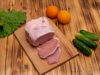 Raw pork meat on chopping block. Preparing for frying.