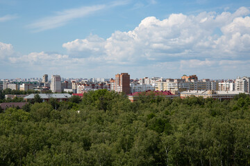 Fototapeta premium View of the buildings from the Ferris wheel in the park named after the 30th anniversary of the Komsomol of Omsk in summer