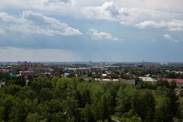 Obraz premium View of the buildings from the Ferris wheel in the park named after the 30th anniversary of the Komsomol of Omsk in summer