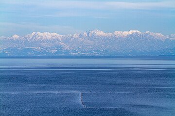 富山県　氷見海岸からの海越しの雪の立山連峰