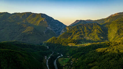 sunrise in mountains with road and river