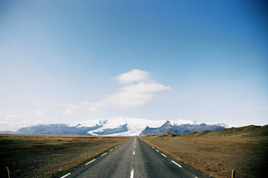 Asphalt road with mountain view in Iceland. Grainy film in the style of old photos