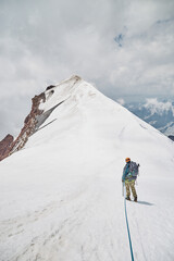 Climbing Kazbek, Georgia. male climber go to the summit.  Nature of Caucasian mountains. Mount Kazbek alpinist expedition