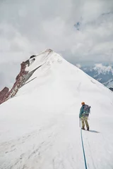 Fotobehang Climbing Kazbek, Georgia. male climber go to the summit.  Nature of Caucasian mountains. Mount Kazbek alpinist expedition © leravalera89