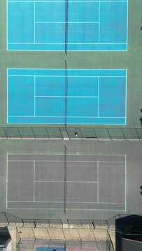 Aerial drone footage of a tennis court in the suburbs of England, UK