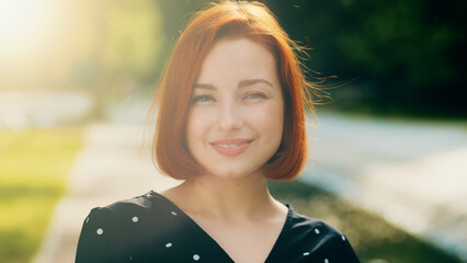 Portrait of happy attractive female face redhead stylish girl with short hairstyle smiling posing...