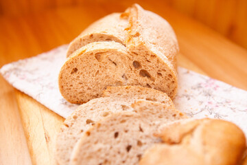 Beautiful backed bread with slices on the table, wheat food