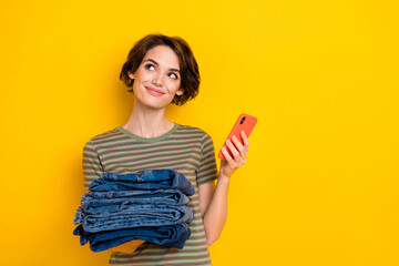 Photo of dreamy funny lady wear striped t-shirt selling stuff modern device empty space isolated yellow color background
