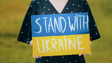 Close up cardboard plate with written inscription stand with Ukraine unknown female activist...