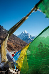 A majestic mountain in Himalaya behind the colorful Tibetan prayer flags.