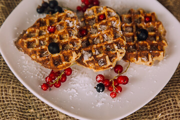 Homemade waffles with berries. Berry Belgian Waffle with raspberries. Culinary, cooking, bakery concept.